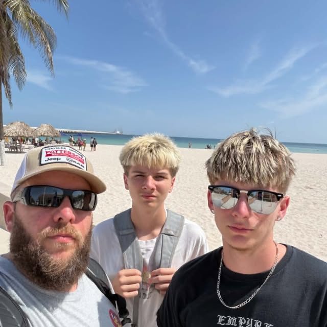 Three travelers on a white-sand beach