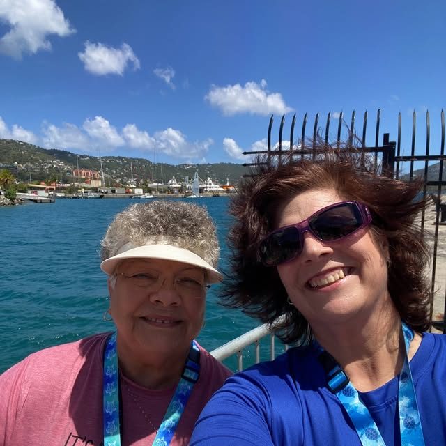 Two friends taking a selfie at a Caribbean harbor