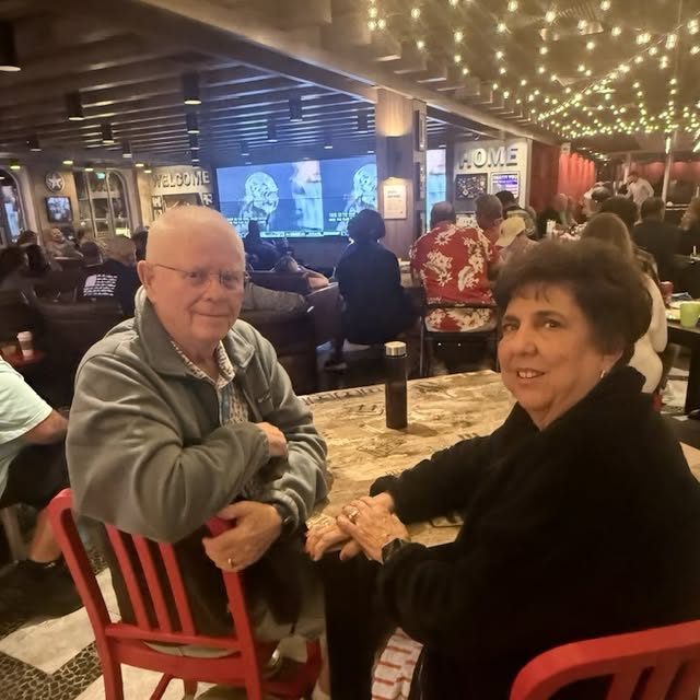 A couple at a table on board a cruise ship