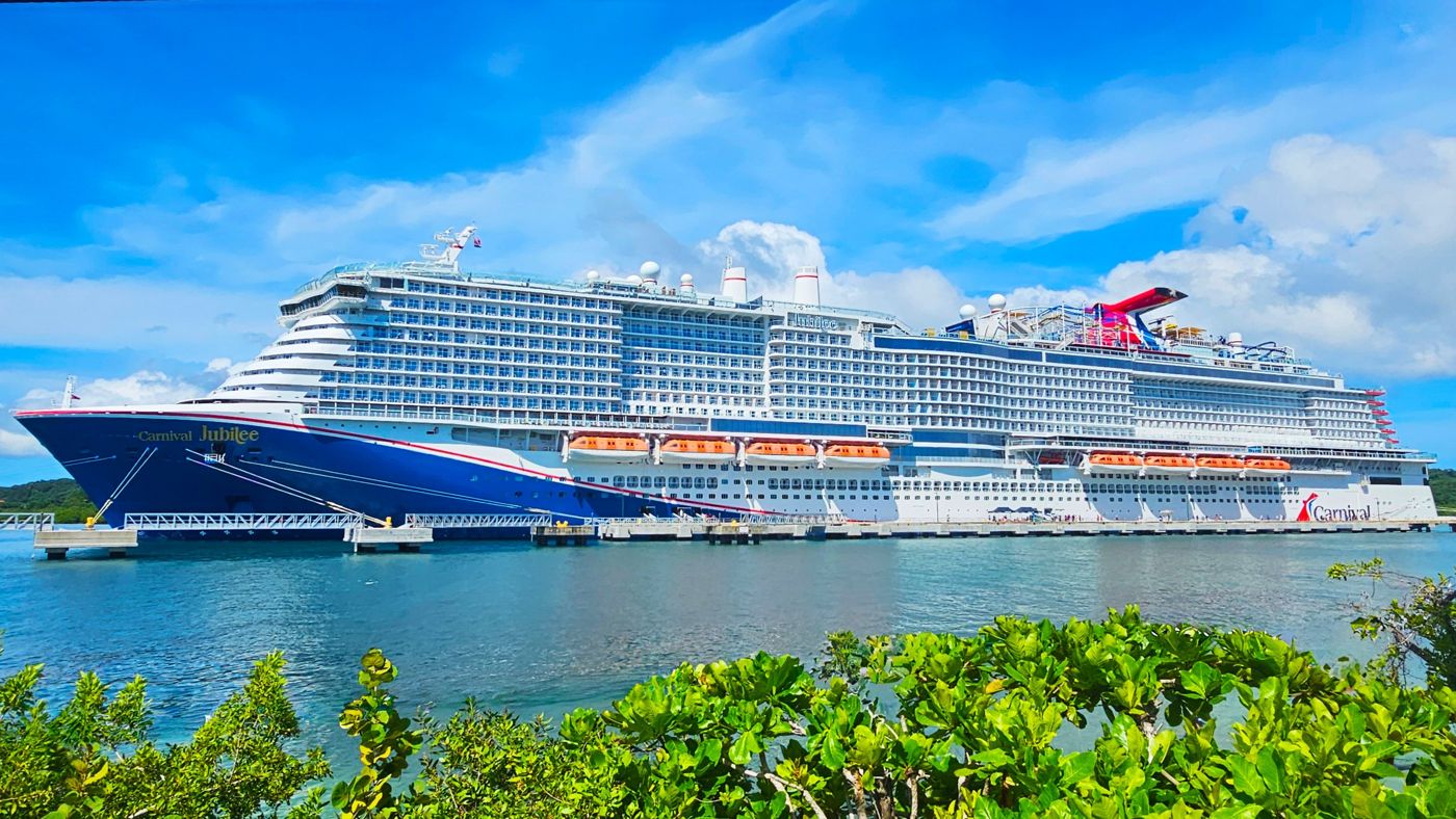 Carnival Jubilee docked beside turquoise water